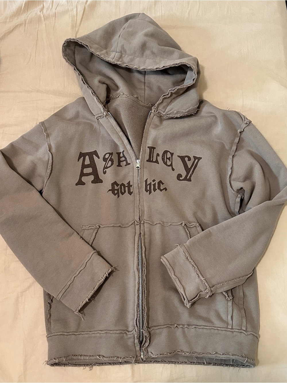 Grey distressed zip up hoodie with brown lettering